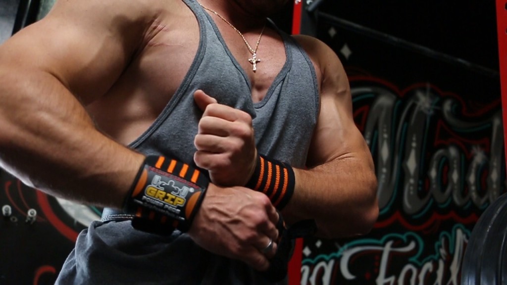 man wearing weight lifting belt and hand straps